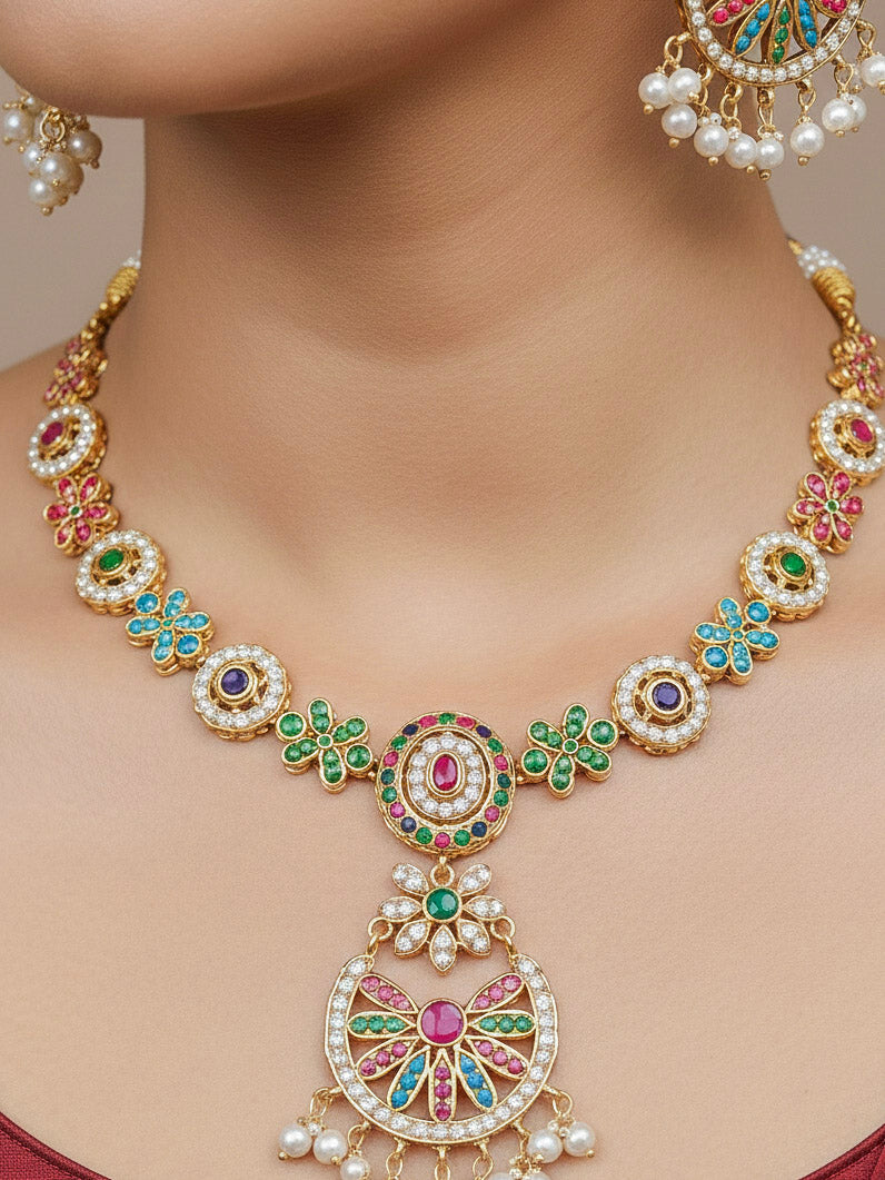 Close-up of a woman wearing an ornate traditional collar Navratan jadau gold jewellery set and jadau earrings with pearls and Navratan gemstones. Elegant  look featuring a luxury Jadau artificial jewelry set. Festive saree look completed with a handcrafted Jadau necklace.