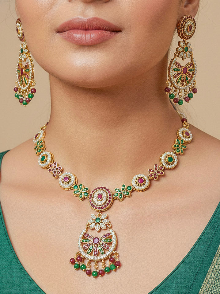 Close-up of a woman wearing an ornate traditional Collar Ruby Pink & Green jadau gold jewellery set and jadau earrings with pearls and Color Stone. Elegant  look featuring a luxury Jadau artificial jewelry set. Close-up of high-quality Jadau artificial necklace craftsmanship.