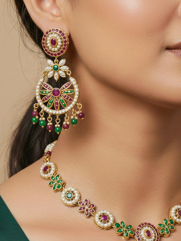 Close-up of a woman wearing an ornate traditional Collar Ruby Pink & Green jadau gold jewellery set and jadau earrings with pearls and Color Stone. Elegant  look featuring a luxury Jadau artificial jewelry set. Close-up of high-quality Jadau artificial necklace craftsmanship.