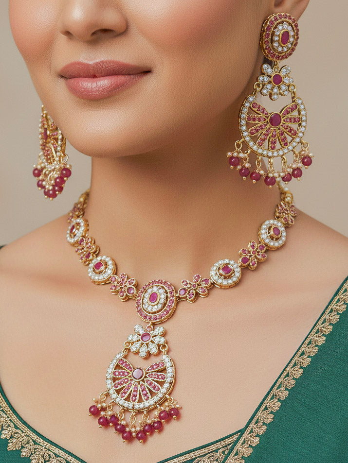 Close-up of a woman wearing an ornate handmade jadau jewelry set and earrings with pink jadau gemstones and beads. This is a perfect jadau jewelry set for weddings, festivals and more. Can also be worn as bridal jadau jewelry for indian weddings. 