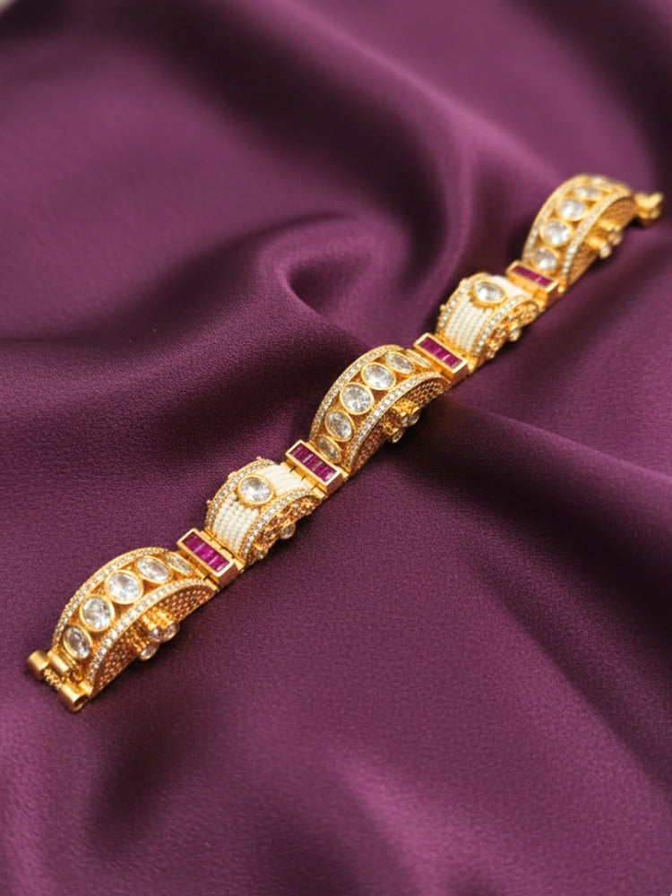 Close-up of an ornate Traditional American Diamond Bracelet with Gold Polish, American Diamond, Colored Stones, Pearls and Filigree Work. Festive outfit paired with a premium imitation American Diamond bracelet in India. Close-up of a high-quality imitation bracelet for festive wear.
