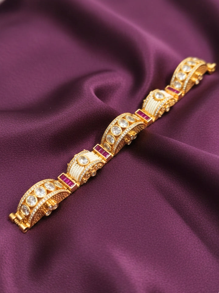 Close-up of an ornate Traditional American Diamond Bracelet with Gold Polish, American Diamond, Colored Stones, Pearls and Filigree Work. Festive outfit paired with a premium imitation American Diamond bracelet in India. Close-up of a high-quality imitation bracelet for festive wear.
