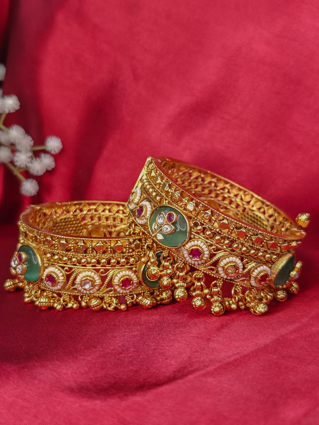 Close-up of an ornate traditional Mint Green Heritage gold Bangle with Colored Stones , Pearls and Kundan. A heritage-inspired artificial Bangles for wedding festivities. Luxury artificial Heritage bangles styled for a wedding function.