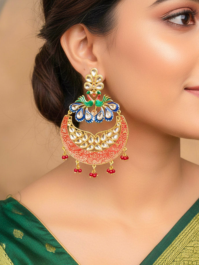 Close-up of a woman wearing an ornate traditional Red Kundan gold Long Earrings with Pearls, Kundan and Meenakari. Lehenga paired with premium artificial wedding Kundan earrings. Close-up of Meenakri earrings styled for a reception party.