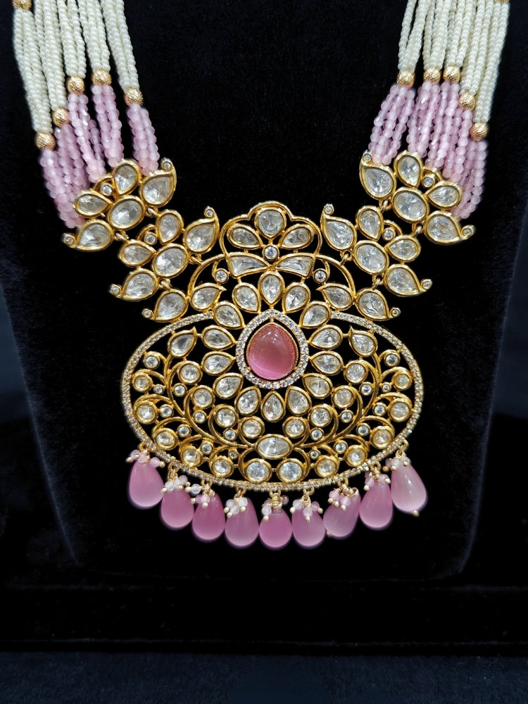 Close-up of an ornate traditional (Gold Polish) Mint Pink Long jewellery set and earrings with Polki, American Diamond, Pearls, Crystal Beads and Tumble Beads. Wedding guest wearing a statement Polki artificial necklace for a reception party. Festive celebration look completed with premium imitation Polki jewelry.