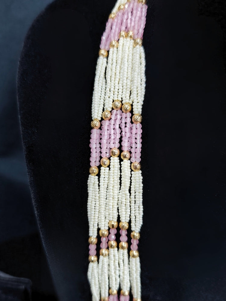 Close-up of an ornate traditional (Gold Polish) Mint Pink Long jewellery set and earrings with Polki, American Diamond, Pearls, Crystal Beads and Tumble Beads. Wedding guest wearing a statement Polki artificial necklace for a reception party. Festive celebration look completed with premium imitation Polki jewelry.