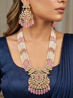 Close-up of a woman wearing an ornate traditional (Gold Polish) Mint Pink Long jewellery set and earrings with Polki, American Diamond, Pearls, Crystal Beads and Tumble Beads. Wedding guest wearing a statement Polki artificial necklace for a reception party. Festive celebration look completed with premium imitation Polki jewelry.