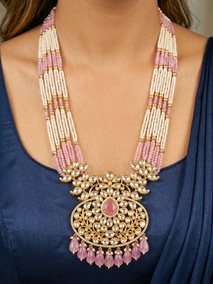 Close-up of a woman wearing an ornate traditional (Gold Polish) Mint Pink Long jewellery set and earrings with Polki, American Diamond, Pearls, Crystal Beads and Tumble Beads. Wedding guest wearing a statement Polki artificial necklace for a reception party. Festive celebration look completed with premium imitation Polki jewelry.