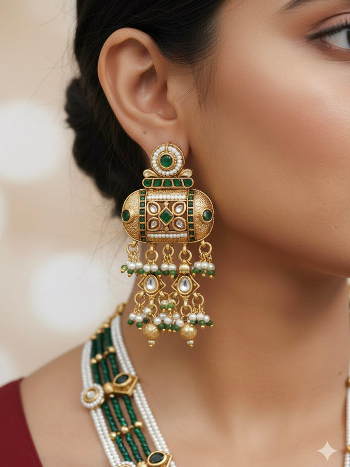 Close-up of a woman wearing an ornate traditional Dark Green Rajwadi gold Long jewellery set and earrings  with Pearls and Hydro Crystal. Woman styled in a royal Rajwadi artificial necklace set for a traditional Indian Festives. Model wearing a royal Rajwadi necklace set for Wedding celebrations in India.