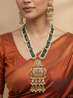 Close-up of a woman wearing an ornate traditional Red and Green Rajwadi gold Long jewellery set and earrings  with Pearls and Hydro Crystal. Bride wearing a premium Rajwadi necklace with a saree for her reception. Festive Diwali outfit enhanced with a Rajwadi artificial necklace.