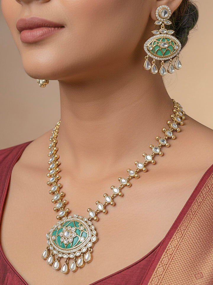 Close-up of a woman wearing an ornate traditional (Mehendi Polish Antique Finish) Sea Green Collar jewellery set and earrings with Kundan, Monalisa Stone, Colored Stones and American Diamond. Woman wearing trending Kundan artificial jewelry for wedding season in India. Festive Diwali outfit paired with a premium Kundan jewelry piece.