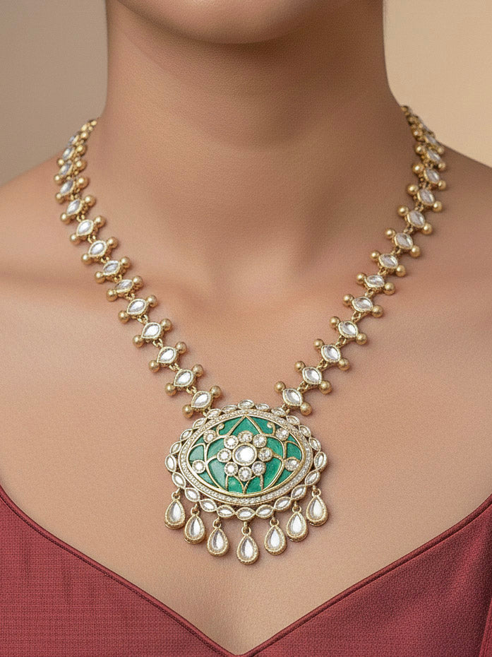 Close-up of a woman wearing an ornate traditional (Mehendi Polish Antique Finish) Sea Green Collar jewellery set and earrings with Kundan, Monalisa Stone, Colored Stones and American Diamond. Woman wearing trending Kundan artificial jewelry for wedding season in India. Festive Diwali outfit paired with a premium Kundan jewelry piece.