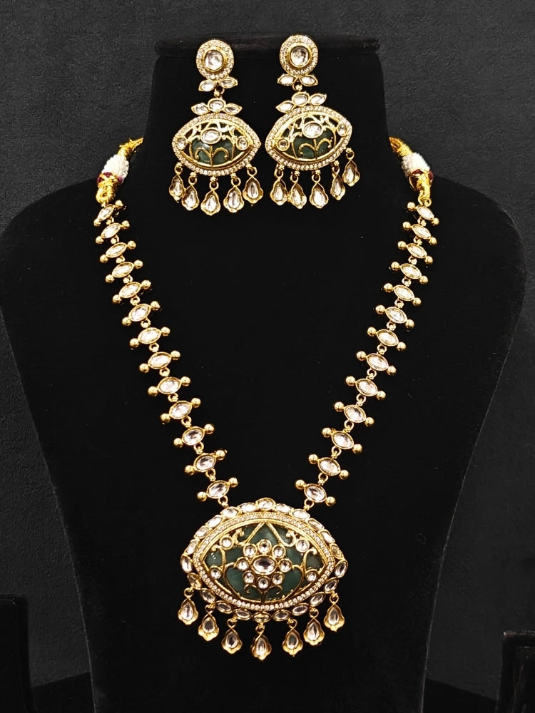Close-up of an ornate traditional (Mehendi Polish Antique Finish) Sea Green Collar jewellery set and earrings with Kundan, Monalisa Stone, Colored Stones and American Diamond. A trending Kundan artificial jewelry for wedding season in India. Festive Diwali outfit paired with a premium Kundan jewelry piece.