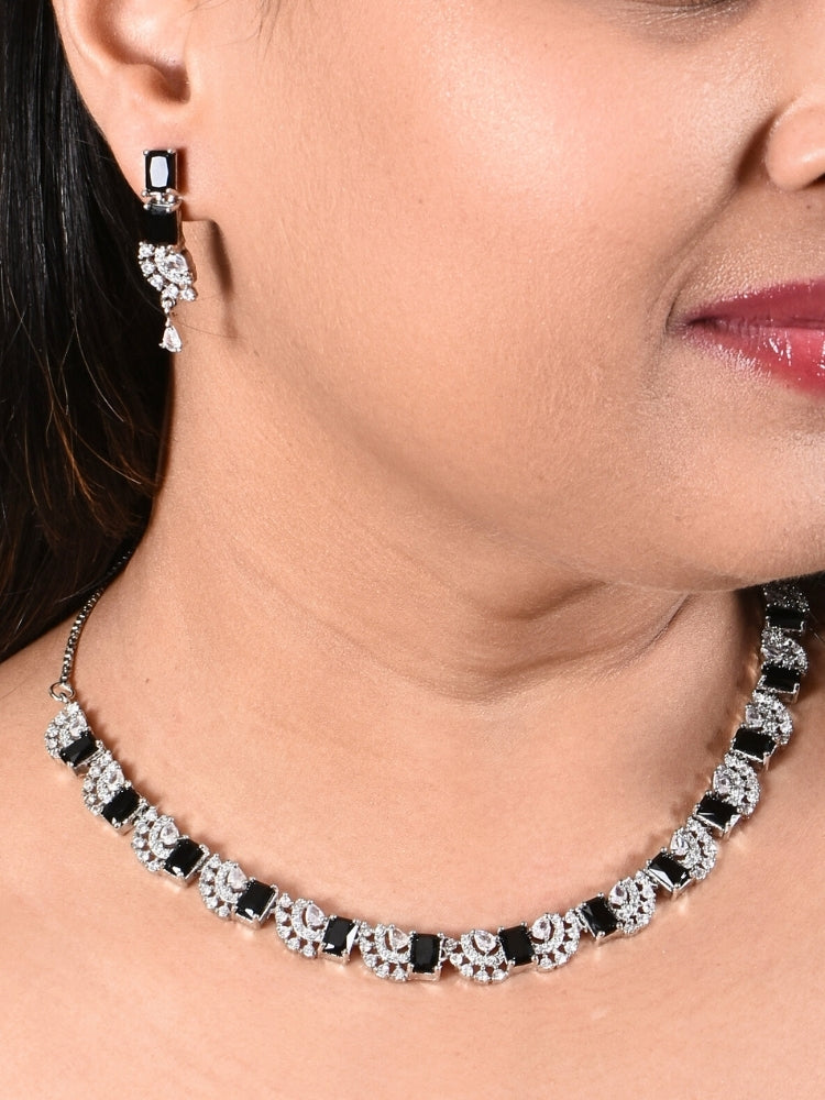 Close-up of a model in luxurious artificial diamond jewelry featuring a designer diamond necklace with black colored stone and earrings set, crafted for bridal fashion and high-end weddings. This beautiful diamond jewelry set offers the brilliance of real diamonds at an affordable price.
