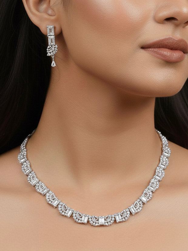A woman in a traditional saree, wearing a gorgeous artificial diamond necklace paired with diamond earrings. This artificial diamond jewelry set offers a traditional yet modern touch for Indian brides, designed to add elegance and sophistication to any occasion.