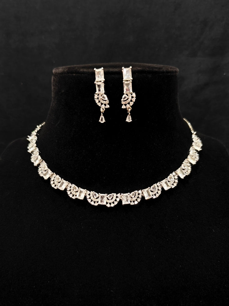 A traditional saree, wearing a gorgeous artificial diamond necklace paired with diamond earrings. This artificial diamond jewelry set offers a traditional yet modern touch for Indian brides, designed to add elegance and sophistication to any occasion.