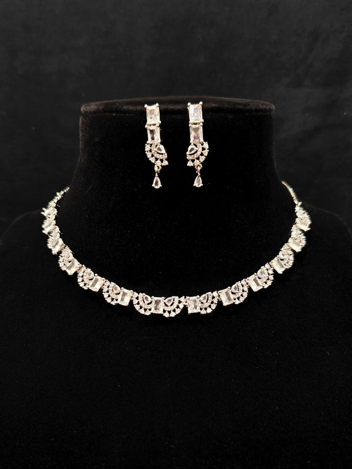 A traditional saree, wearing a gorgeous artificial diamond necklace paired with diamond earrings. This artificial diamond jewelry set offers a traditional yet modern touch for Indian brides, designed to add elegance and sophistication to any occasion.