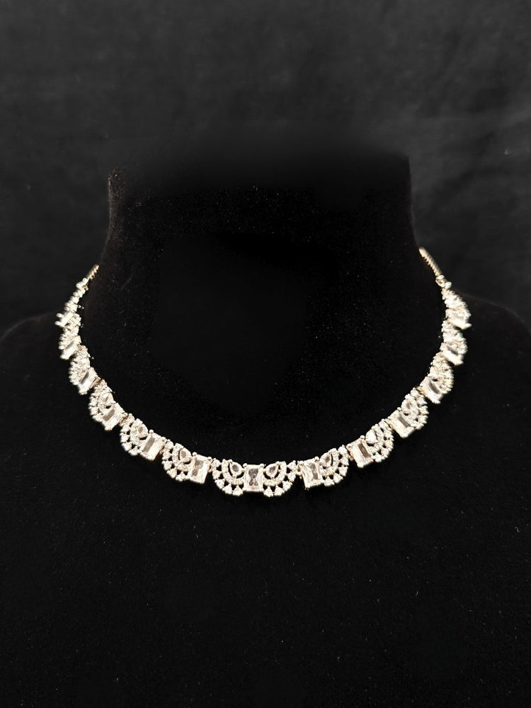 A traditional saree, wearing a gorgeous artificial diamond necklace paired with diamond earrings. This artificial diamond jewelry set offers a traditional yet modern touch for Indian brides, designed to add elegance and sophistication to any occasion.