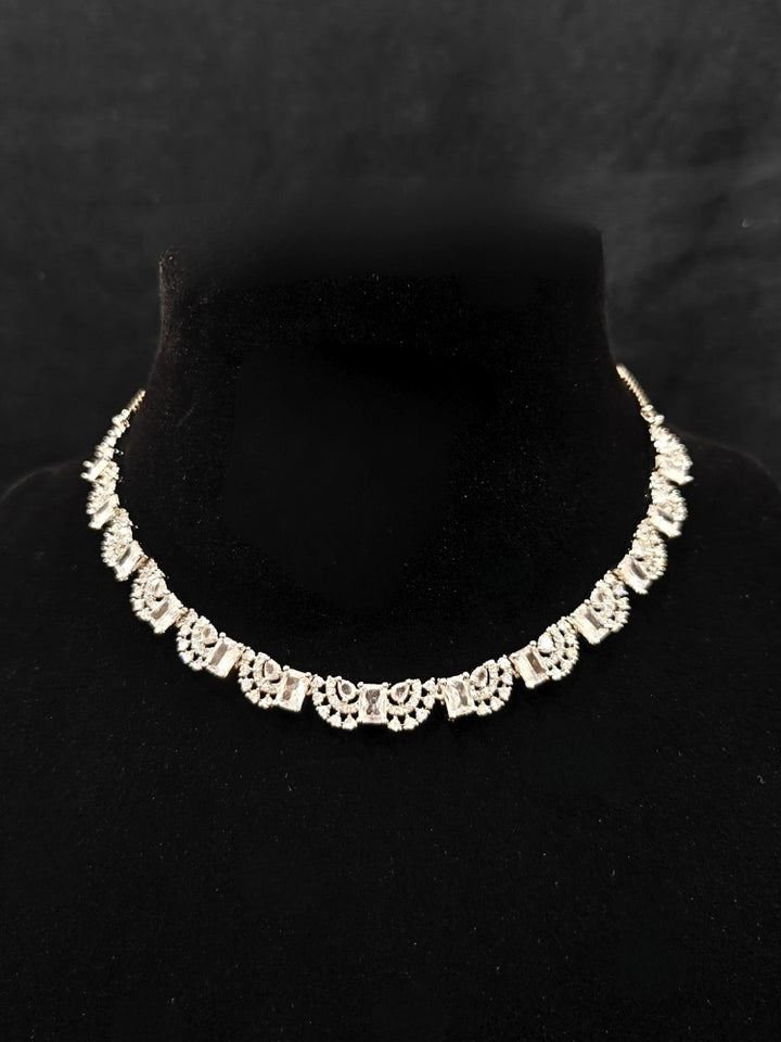 A traditional saree, wearing a gorgeous artificial diamond necklace paired with diamond earrings. This artificial diamond jewelry set offers a traditional yet modern touch for Indian brides, designed to add elegance and sophistication to any occasion.