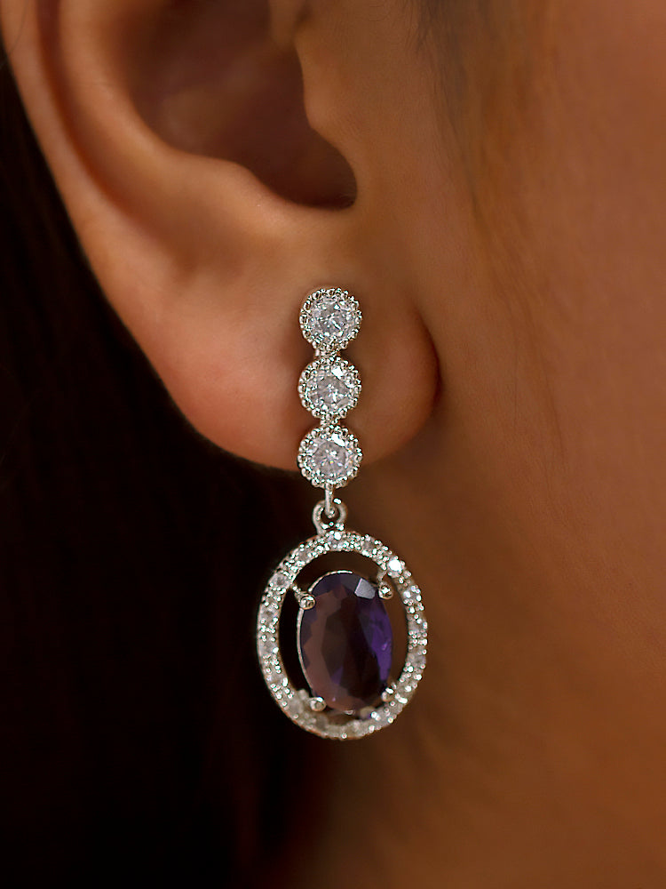 Close-up of a woman wearing a stunning affordable artificial diamond necklace with purple colored stone and matching earrings set, perfect for wedding guests and formal events. This luxury artificial diamond jewelry provides the brilliance of real diamonds at a fraction of the cost.