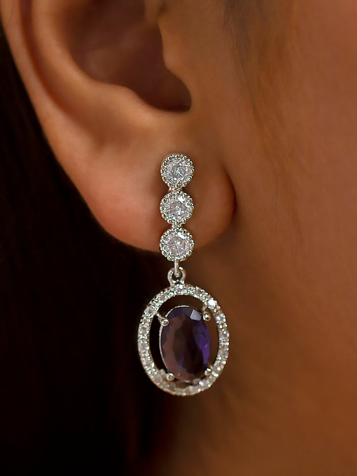 Close-up of a woman wearing a stunning affordable artificial diamond necklace with purple colored stone and matching earrings set, perfect for wedding guests and formal events. This luxury artificial diamond jewelry provides the brilliance of real diamonds at a fraction of the cost.