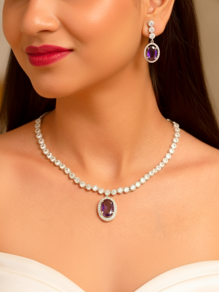 Close-up of a woman wearing a sparkling artificial diamond necklace with purple colored stone and diamond earrings set, designed to offer a radiant, elegant look for any formal occasion or Indian wedding. This affordable diamond jewelry provides a flawless, luxurious alternative to natural diamonds.