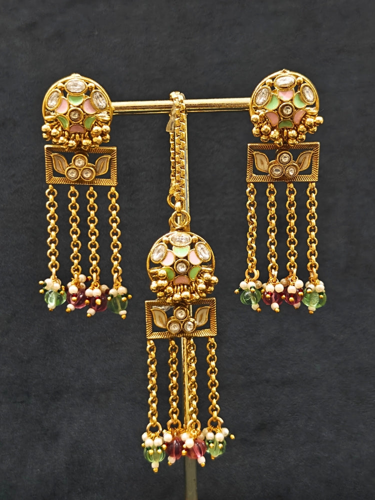 Close-up of an ornate traditional Mint Pink and Green Heritage gold Collar jewellery set and earrings and maangtikka with Beads, Colored Stones and Kundan.  A heritage-inspired artificial necklace for wedding festivities. Saree styling inspiration with a traditional heritage necklace.