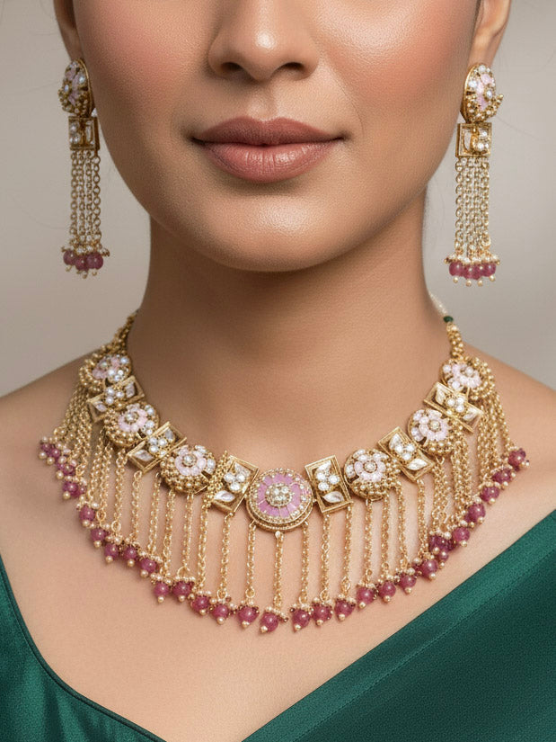 Close-up of a woman wearing an ornate traditional Mint Pink Heritage gold Collar jewellery set and earrings and maangtikka with Beads, Colored Stones and Kundan. Woman wearing a heritage-inspired artificial necklace for wedding festivities. Saree styling inspiration with a traditional heritage necklace.