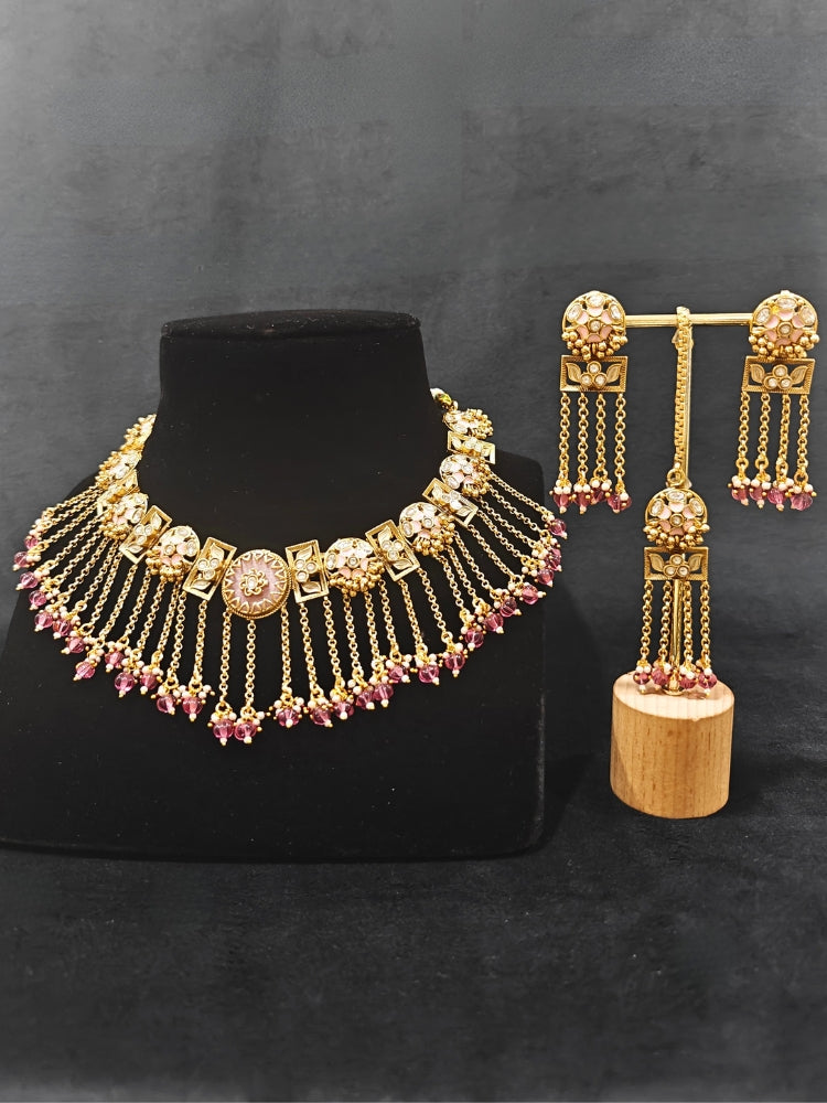 Close-up of an ornate traditional Mint Pink Heritage gold Collar jewellery set and earrings and maangtikka with Beads, Colored Stones and Kundan. A heritage-inspired artificial necklace for wedding festivities. Saree styling inspiration with a traditional heritage necklace.