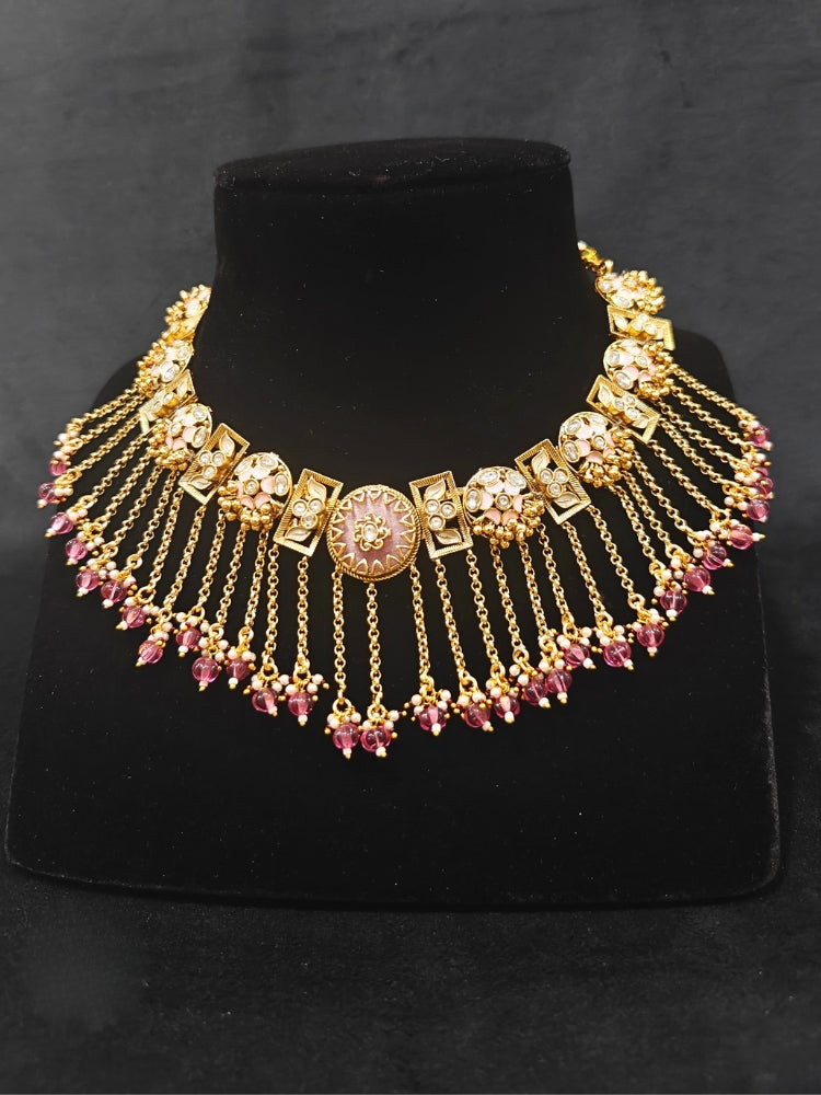 Close-up of an ornate traditional Mint Pink Heritage gold Collar jewellery set and earrings and maangtikka with Beads, Colored Stones and Kundan. A heritage-inspired artificial necklace for wedding festivities. Saree styling inspiration with a traditional heritage necklace.