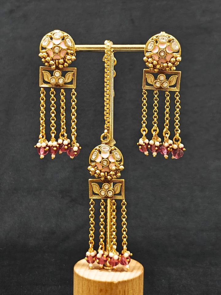 Close-up of an ornate traditional Mint Pink Heritage gold Collar jewellery set and earrings and maangtikka with Beads, Colored Stones and Kundan. A heritage-inspired artificial necklace for wedding festivities. Saree styling inspiration with a traditional heritage necklace.