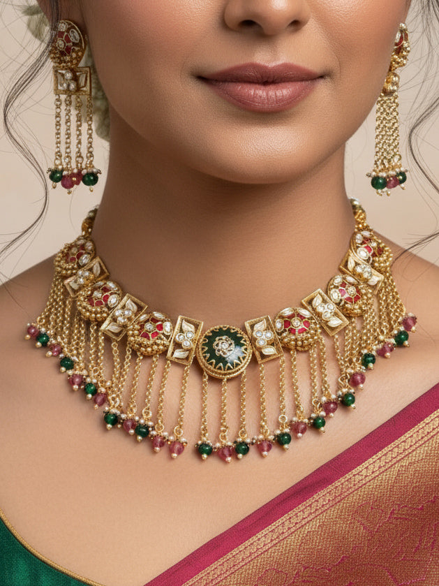 Close-up of a woman wearing an ornate traditional Red and Green Heritage gold Collar jewellery set and earrings and maangtikka with Beads, Colored Stones and Kundan. Woman wearing a heritage-inspired artificial necklace for wedding festivities. Saree styling inspiration with a traditional heritage necklace.