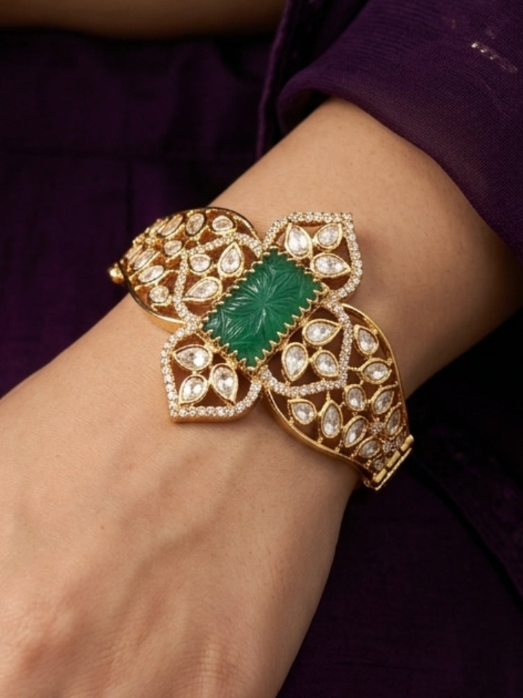 Close-up of a woman wearing an ornate traditional (Gold Polish) Mint Green Bracelet with Polki, American Diamond and Carved Stone. Close-up of an anti-tarnish artificial Polki bracelet styled for wedding guests. Elegant saree look completed with a luxury artificial Polki bracelet.