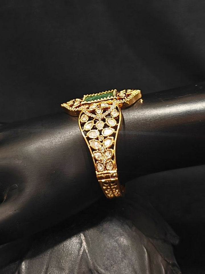  Close-up of an ornate traditional (Gold Polish) Mint Green Bracelet with Polki, American Diamond and Carved Stone. Close-up of an anti-tarnish artificial Polki bracelet styled for wedding guests. Elegant saree look completed with a luxury artificial Polki bracelet.