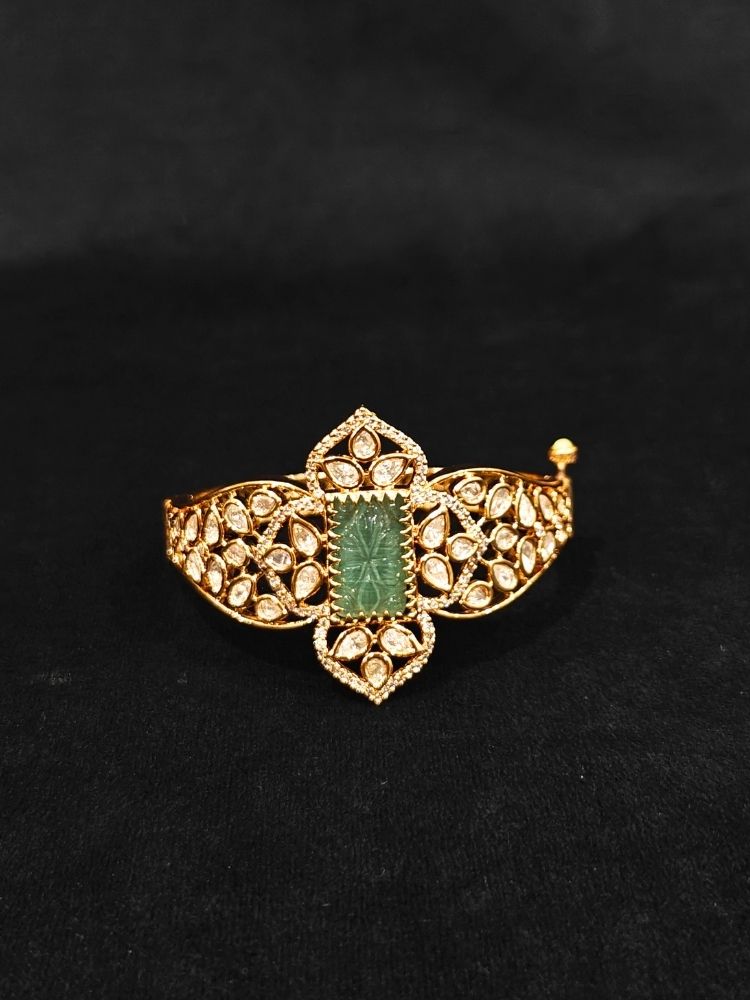 Close-up of an ornate traditional (Gold Polish) Mint Green Bracelet with Polki, American Diamond and Carved Stone. Close-up of an anti-tarnish artificial Polki bracelet styled for wedding guests. Elegant saree look completed with a luxury artificial Polki bracelet.