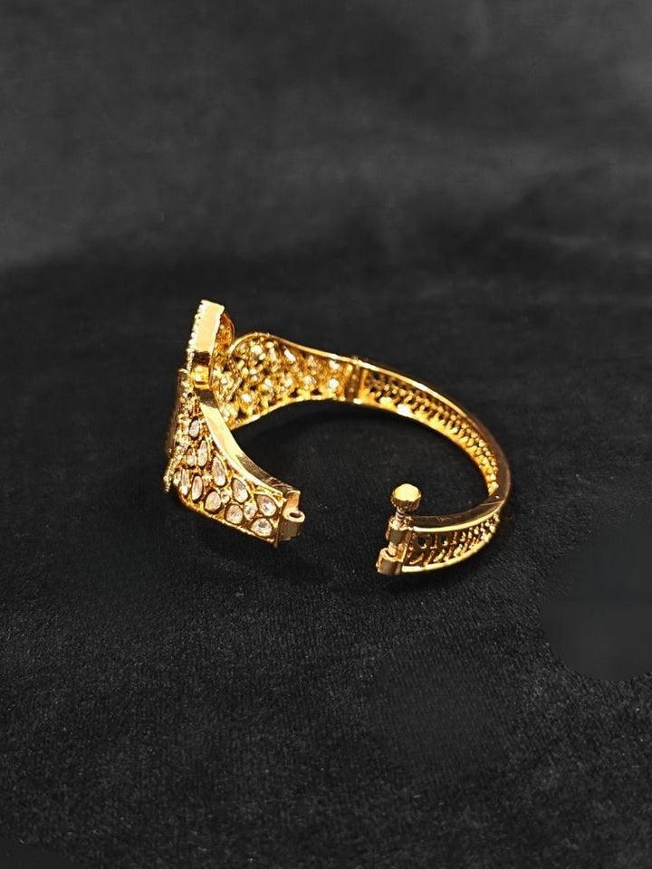 Close-up of an ornate traditional (Gold Polish) Mint Green Bracelet with Polki, American Diamond and Carved Stone. Close-up of an anti-tarnish artificial Polki bracelet styled for wedding guests. Elegant saree look completed with a luxury artificial Polki bracelet.