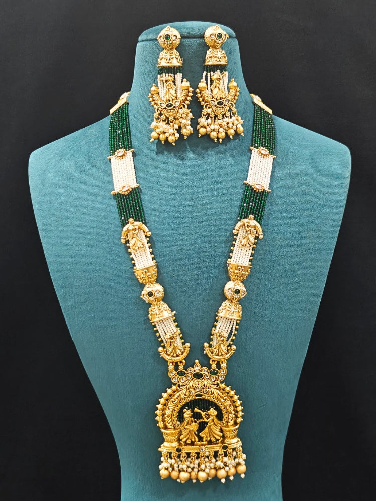 Close-up of an ornate traditional Dark Green Rajwadi gold Long jewellery set and earrings  with Pearls, Hydro Crystal and Bandhai Work. Close-up of detailed Rajwadi craftsmanship in artificial jewelry.
Traditional Indian look featuring a Rajwadi necklace set. Perfect  Rajwadi necklace set for weddings and festivals