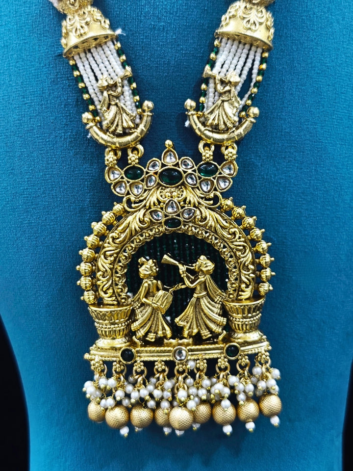 Close-up of an ornate traditional Dark Green Rajwadi gold Long jewellery set and earrings  with Pearls, Hydro Crystal and Bandhai Work. Close-up of detailed Rajwadi craftsmanship in artificial jewelry.
Traditional Indian look featuring a Rajwadi necklace set. Perfect  Rajwadi necklace set for weddings and festivals