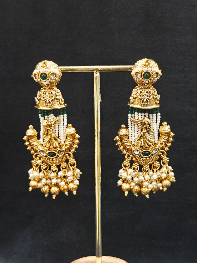 Close-up of an ornate traditional Dark Green Rajwadi gold Long jewellery set and earrings  with Pearls, Hydro Crystal and Bandhai Work. Close-up of detailed Rajwadi craftsmanship in artificial jewelry.
Traditional Indian look featuring a Rajwadi necklace set. Perfect  Rajwadi necklace set for weddings and festivals