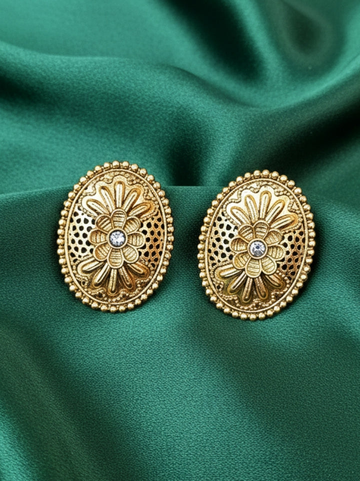 Close-up of an ornate traditional (Gold Polish) Studs Earrings with Filigree Work and Kundan. Festive Diwali outfit paired with a colorful Filigree Work Earrings. Festive celebration look enhanced with traditional Kundan Earrings.