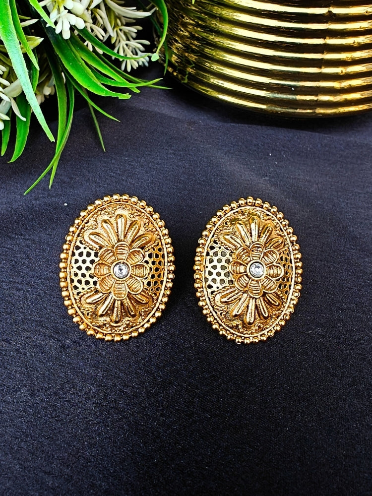Close-up of an ornate traditional (Gold Polish) Studs Earrings with Filigree Work and Kundan. Festive Diwali outfit paired with a colorful Filigree Work Earrings. Festive celebration look enhanced with traditional Kundan Earrings.