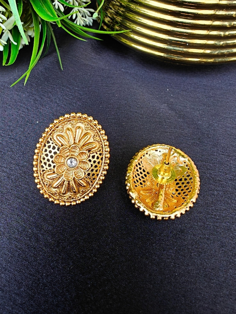 Close-up of an ornate traditional (Gold Polish) Studs Earrings with Filigree Work and Kundan. Festive Diwali outfit paired with a colorful Filigree Work Earrings. Festive celebration look enhanced with traditional Kundan Earrings.