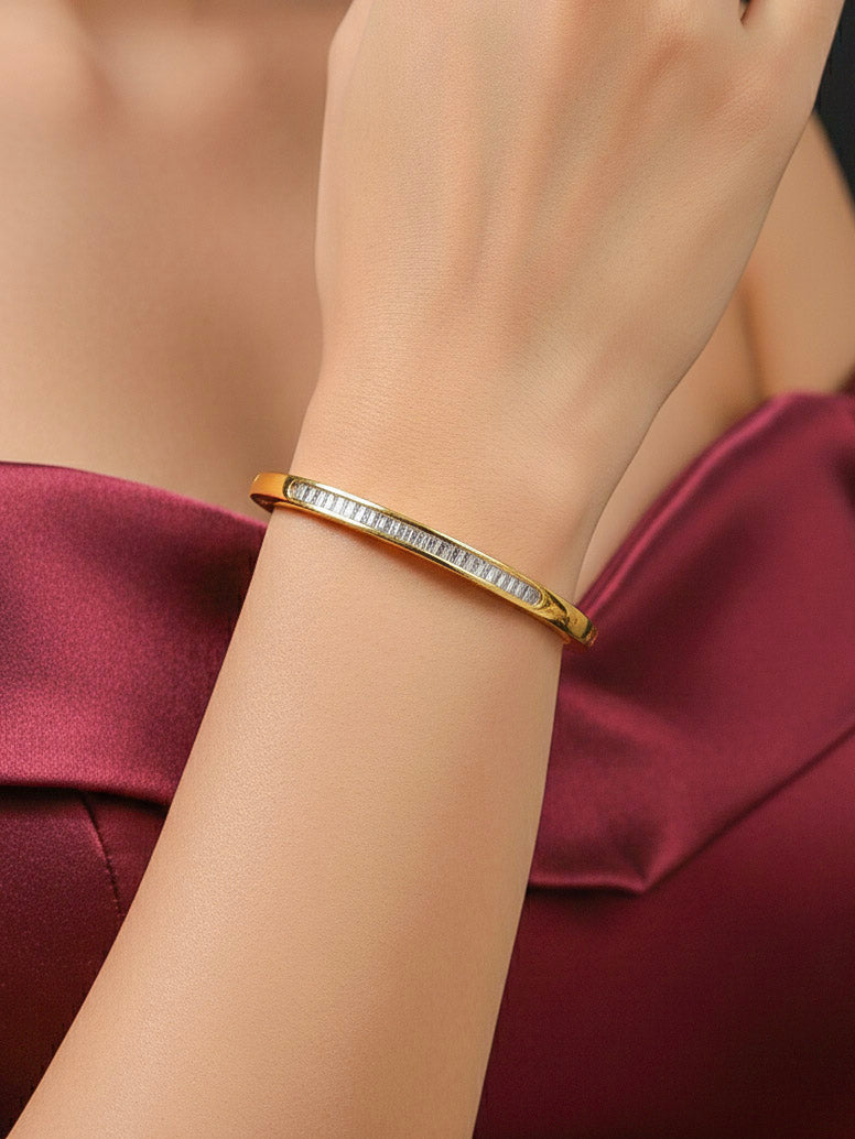 Close-up of a woman wearing an ornate Western (Gold Polish) Bracelet with American Diamond. Festive outfit paired with a premium imitation American Diamond bracelet in India. Close-up of skin-friendly artificial jewelry American Diamond bracelet in India.