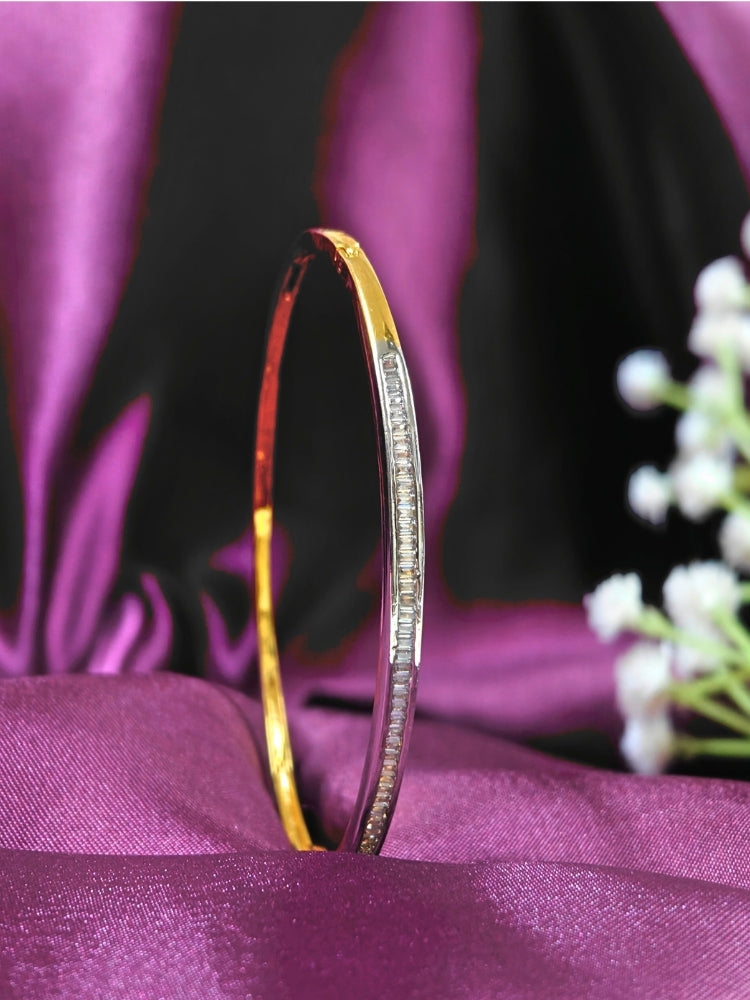 Close-up of an ornate Western (Gold Polish) Bracelet with American Diamond. Festive outfit paired with a premium imitation American Diamond bracelet in India. Close-up of skin-friendly artificial jewelry American Diamond bracelet in India.