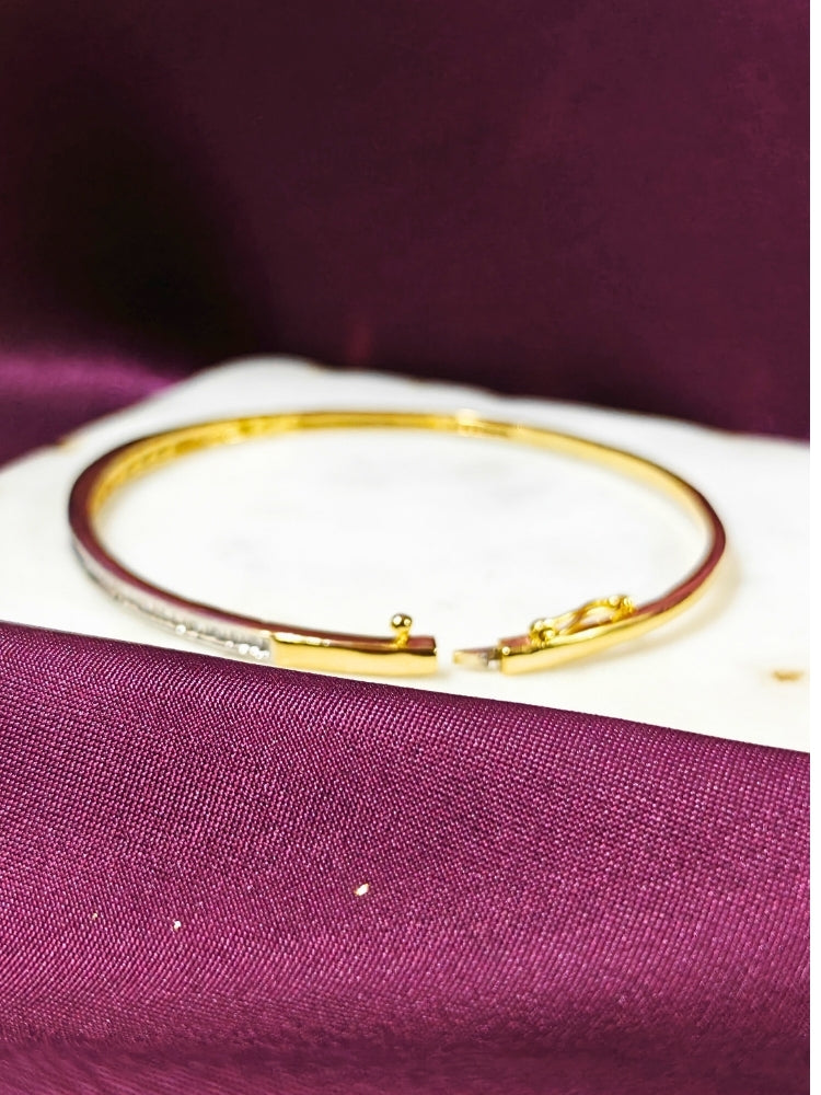Close-up of an ornate Western (Gold Polish) Bracelet with American Diamond. Festive outfit paired with a premium imitation American Diamond bracelet in India. Close-up of skin-friendly artificial jewelry American Diamond bracelet in India.