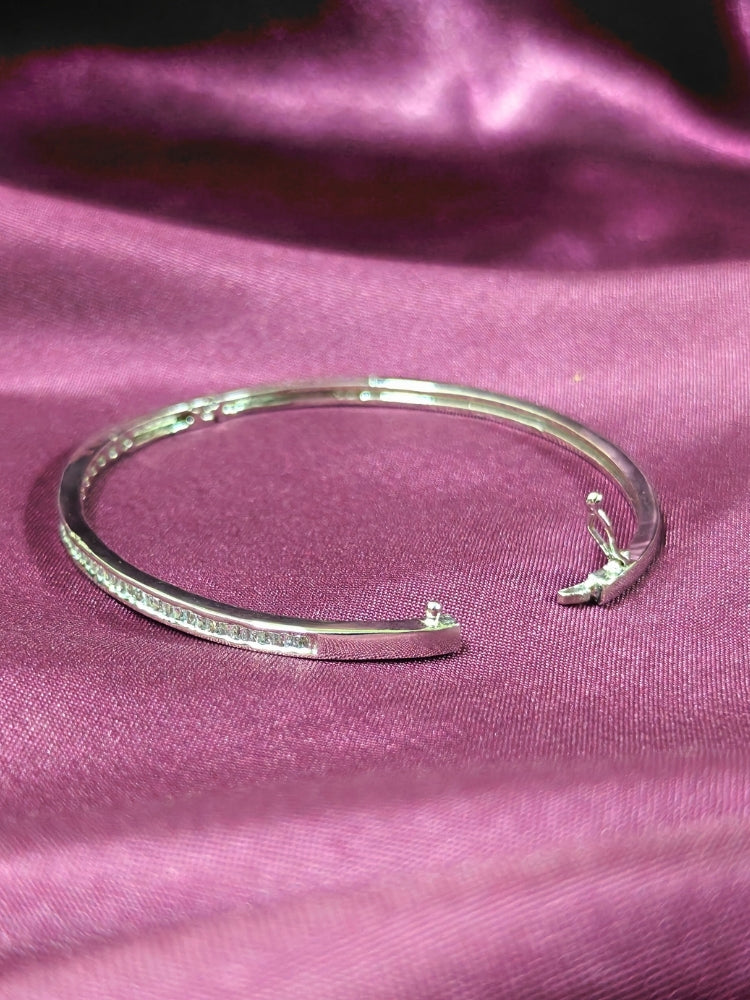 Close-up of an ornate Western (Silver Polish) Bracelet with American Diamond. Festive outfit paired with a premium imitation American Diamond bracelet in India. Close-up of skin-friendly artificial jewelry American Diamond bracelet in India.