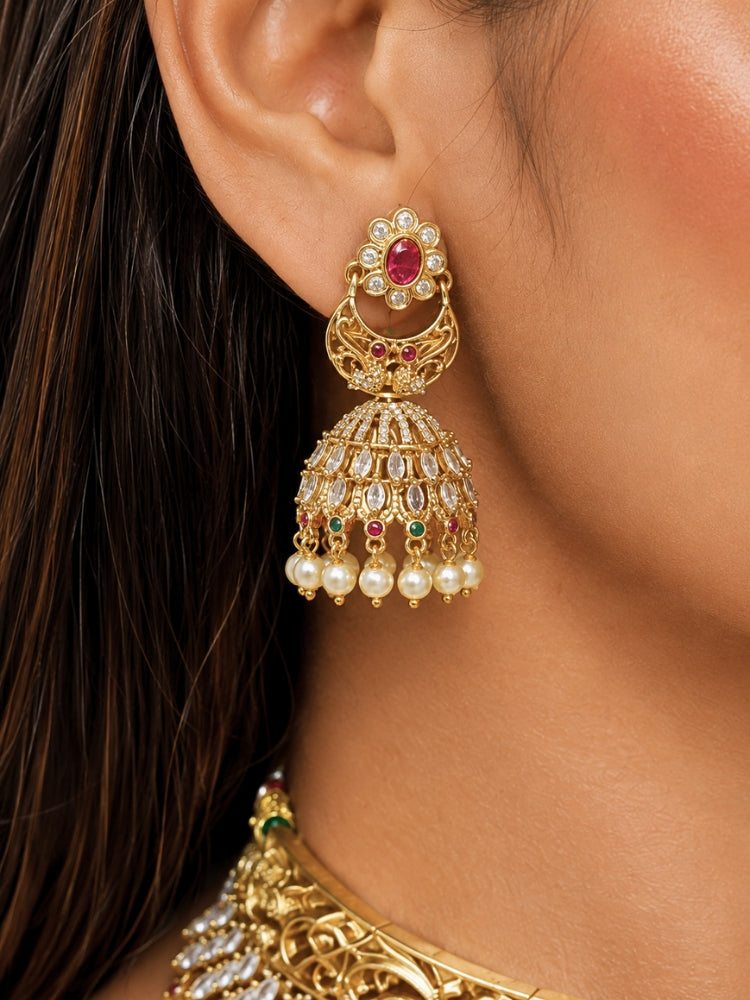Close-up of a women wearing an ornate traditional (Gold Polish) Choker jewellery set and earrings with American Diamond and Pearls. A woman wearing a luxury American diamond necklace set styled beautifully for a wedding guest look in India. Elegant wedding jewelry look featuring a premium artificial American diamond necklace.