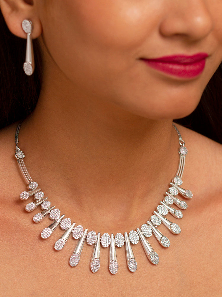 A woman showcasing a beautiful artificial diamond necklace and earrings set, the cascading pattern adds movement and brilliance, making it an ideal choice for weddings, evening events, parties, and special occasions. Designed to complement both traditional and modern outfits, this elegant jewelry set delivers timeless glamour and refined style.