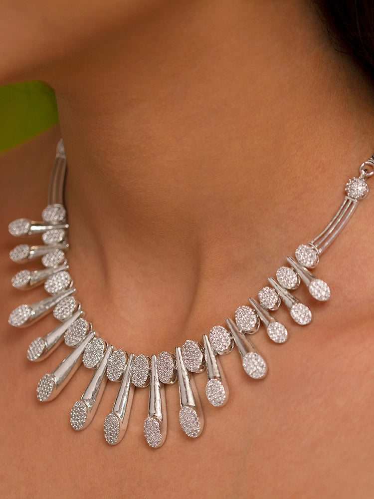 Close-up of a woman wearing a sparkling artificial diamond necklace and diamond earrings set, designed to offer a radiant, elegant look for any formal occasion or Indian wedding. This affordable diamond jewelry provides a flawless, luxurious alternative to natural diamonds.