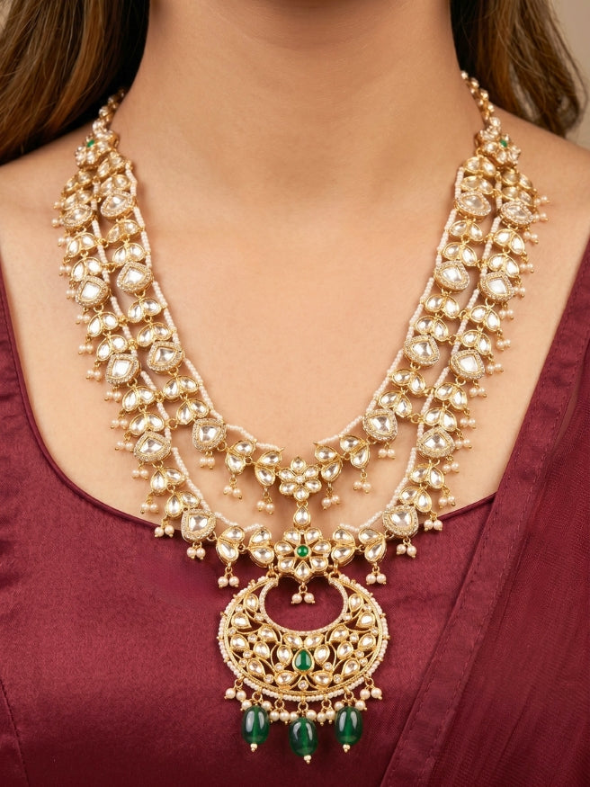 Close-up of a woman wearing an ornate traditional (Gold Polish) Green Long jewellery set and earrings with Polki, American Diamond and Pearl. Festive Diwali look enhanced with a premium Polki artificial necklace. Wedding guest outfit styled with an elegant Polki necklace set.Close-up of high-quality imitation Polki jewelry for bridal wear.